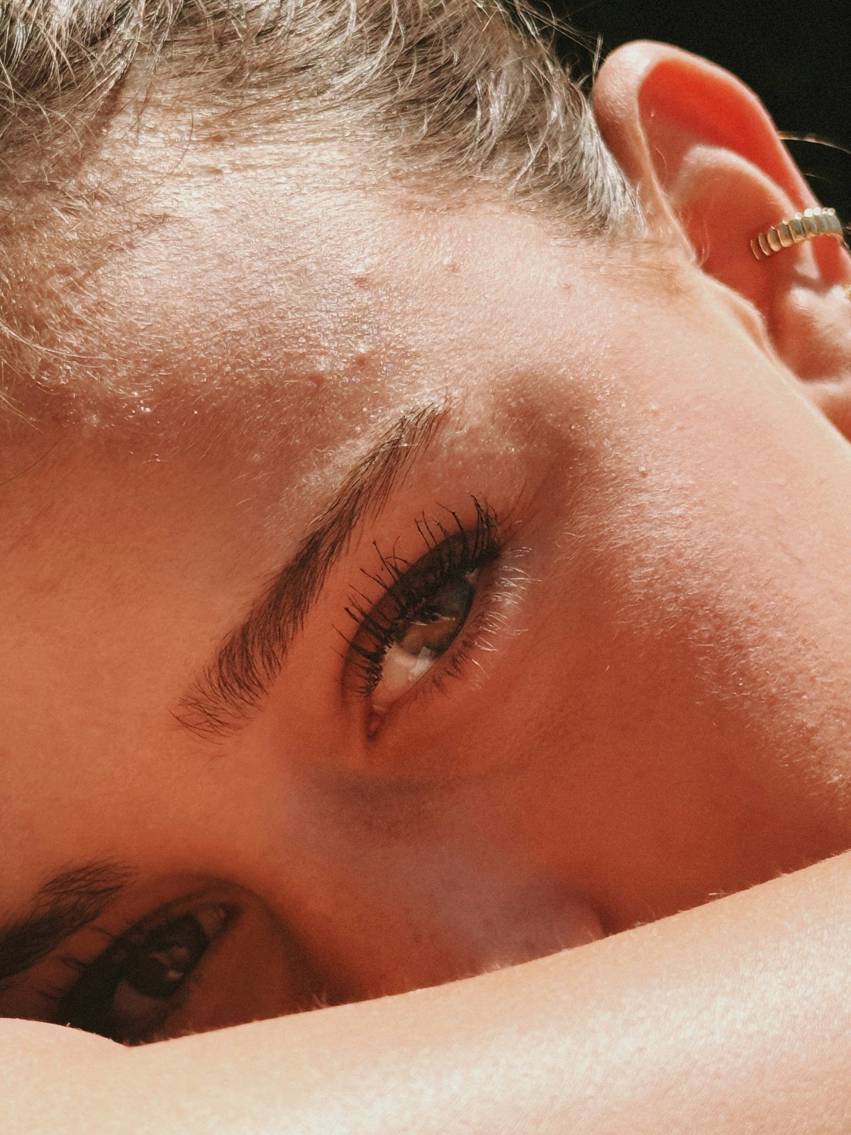 Close-up of a woman resting her head on her arm