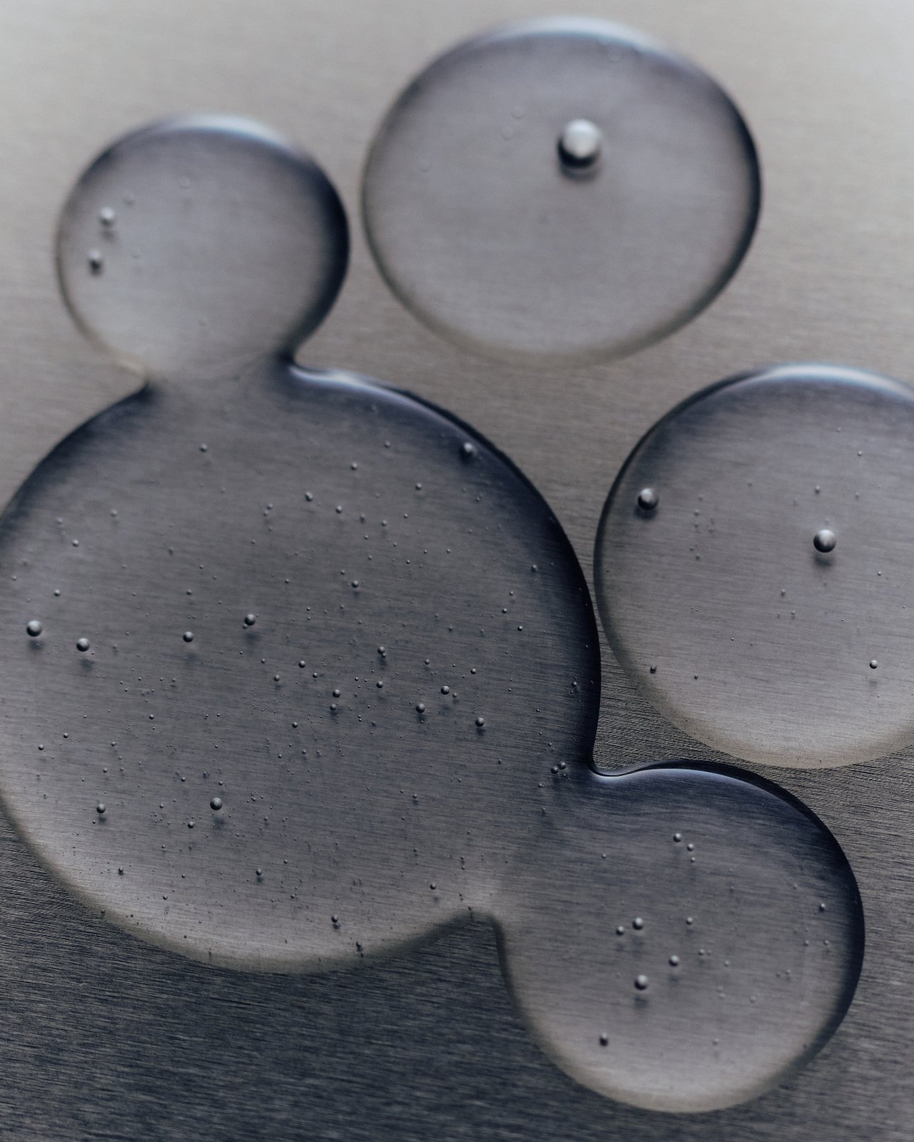 Clear serum droplets on a metal surface